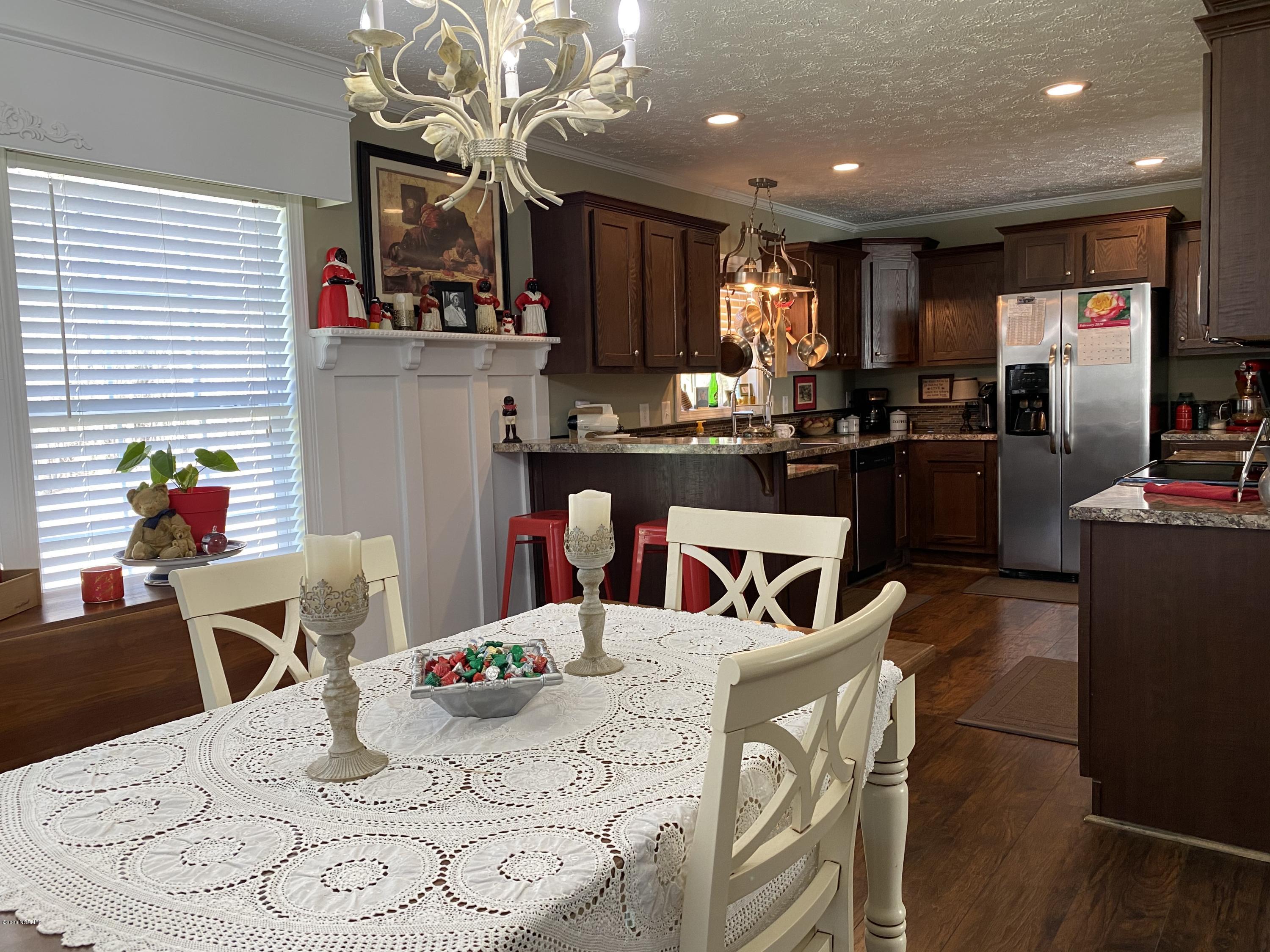 7022 Kingtown Road Northwest Ash, NC 28420 - Photo 13 of 34 In the dining area, there is wainscoting with a plate rail and dental molding that provides the perfect mix of function and style.
