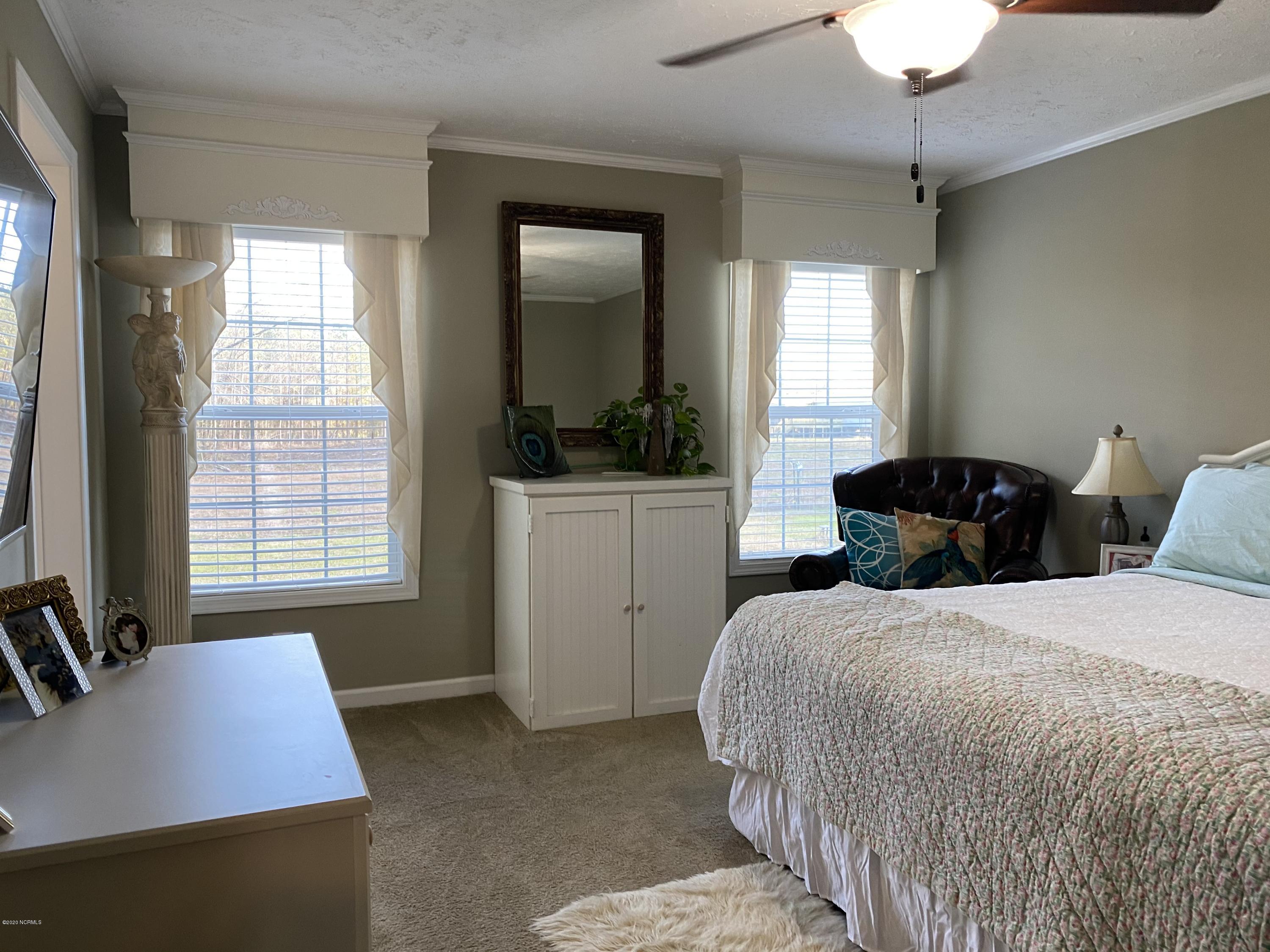7022 Kingtown Road Northwest Ash, NC 28420 - Photo 16 of 34 Plenty of natural light floods this room. The owners suite has a large walk-in closet.