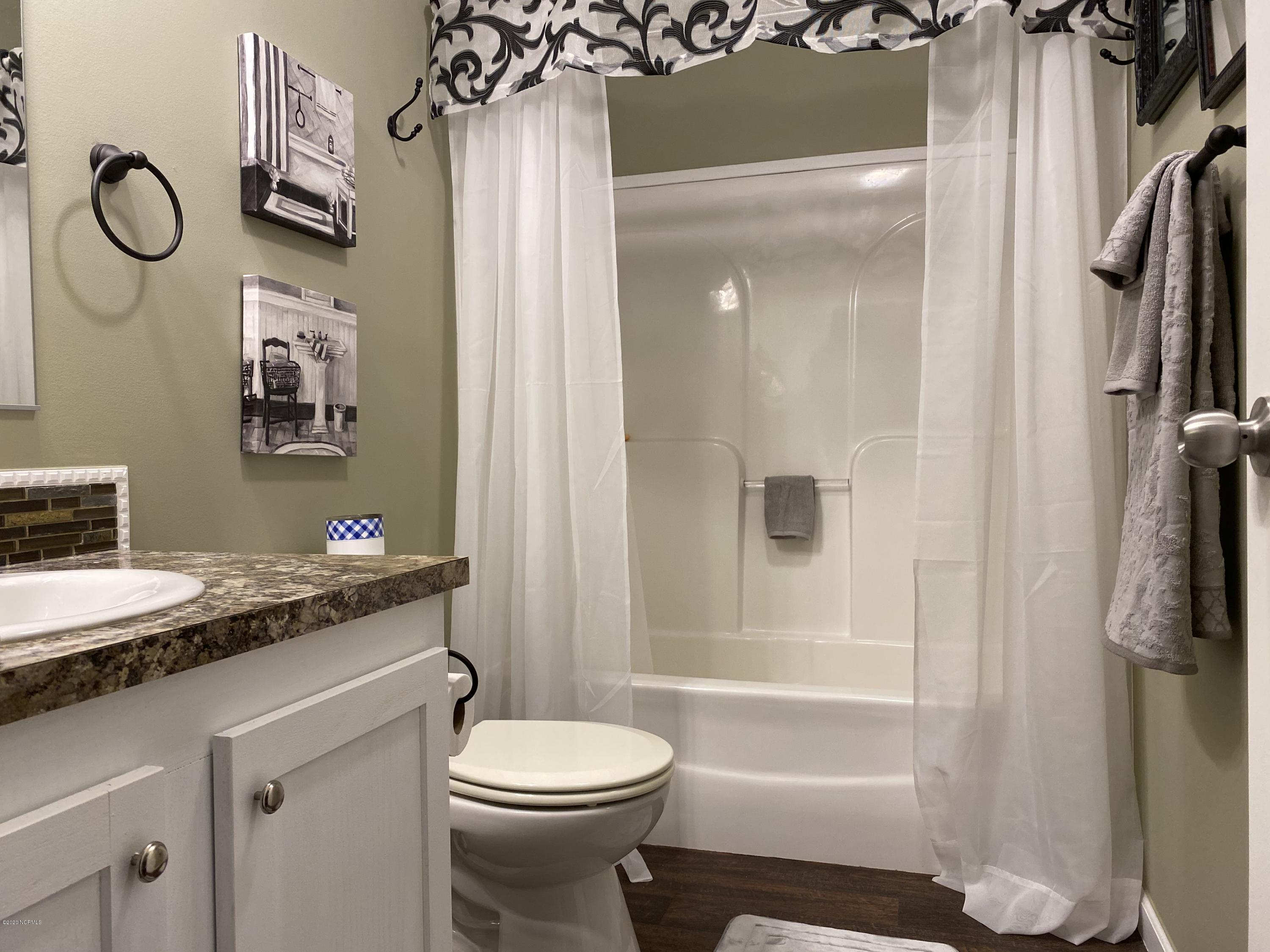 7022 Kingtown Road Northwest Ash, NC 28420 - Photo 25 of 34 Easy access to the Guest Bathroom form the Great Room or bedrooms.