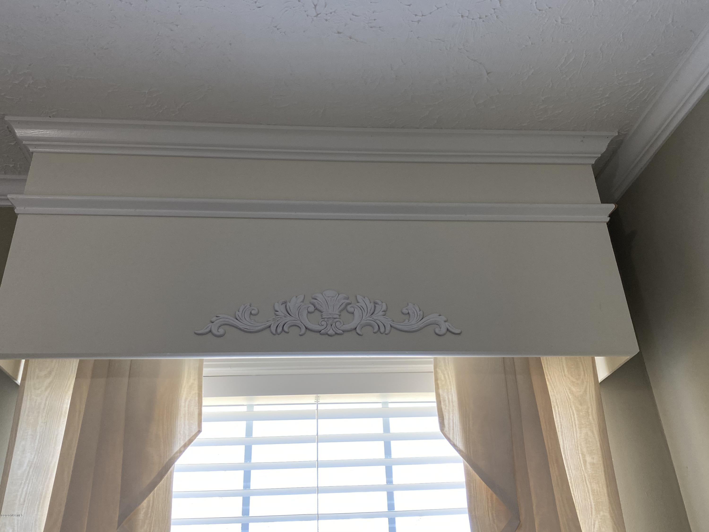 7022 Kingtown Road Northwest Ash, NC 28420 - Photo 27 of 34 Custom Cornices can be found on the interior windows of the Owners Suite, Great Room/Living Room and the Dining Area.