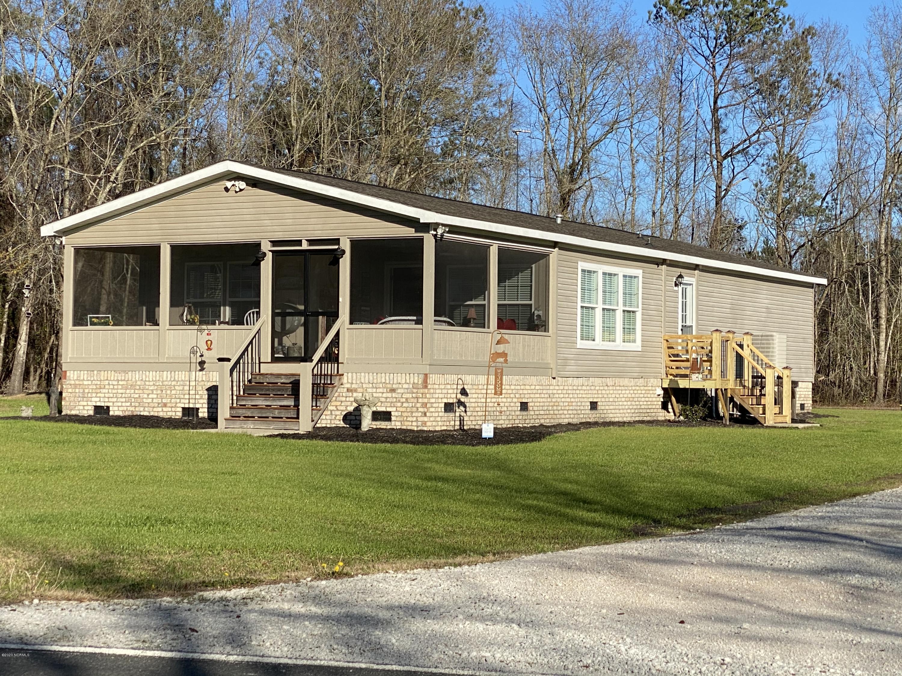 7022 Kingtown Road Northwest Ash, NC 28420 - Photo 29 of 34 Do you like to hunt? Fish? Use your boat? There is a wooded area to the left of the home.