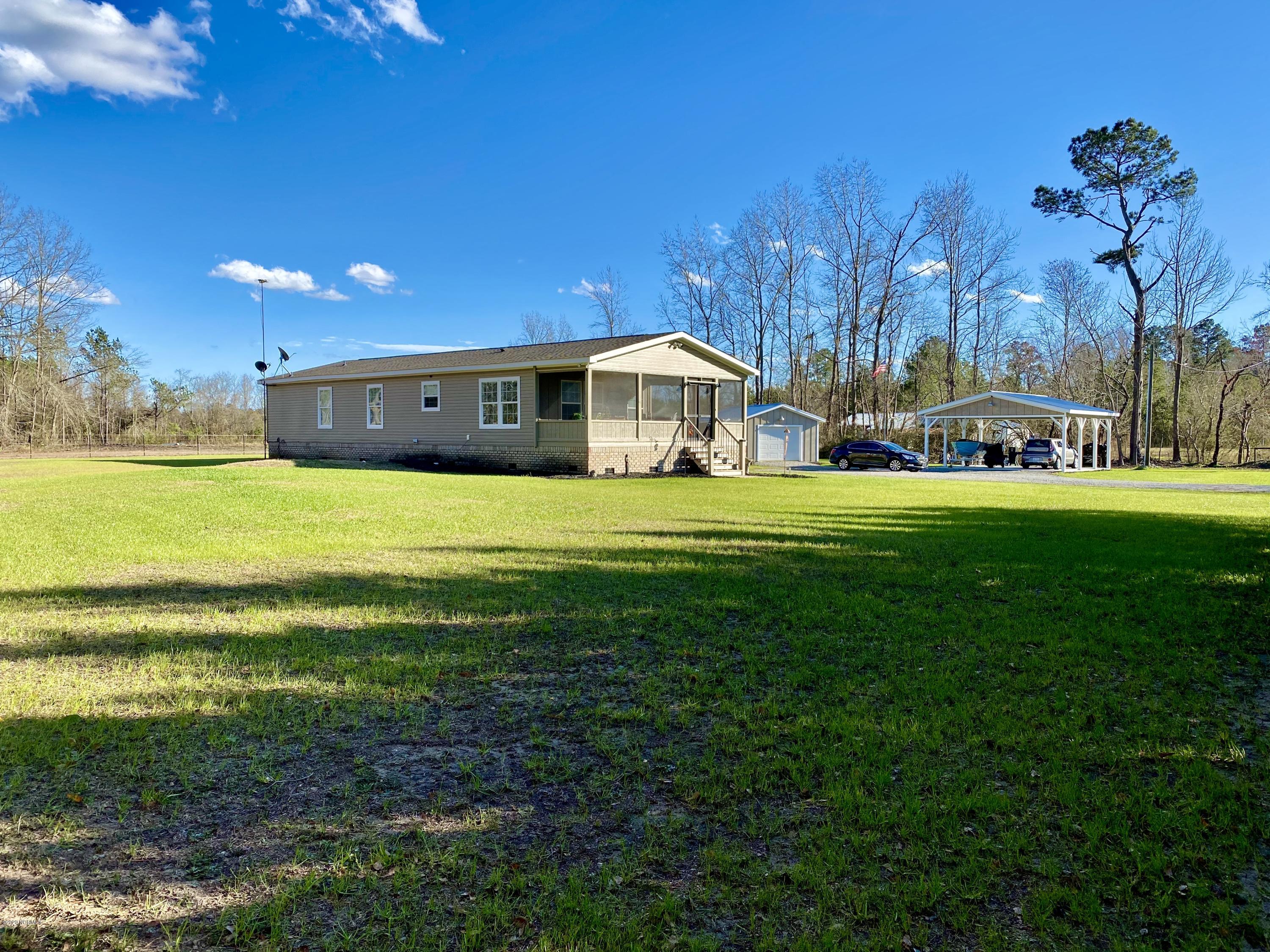 7022 Kingtown Road Northwest Ash, NC 28420 - Photo 30 of 34 There is detached garage with a metal roof and a double car port with a metal roof where you can park your tractor, duck boat, RV, or lawn equipment.