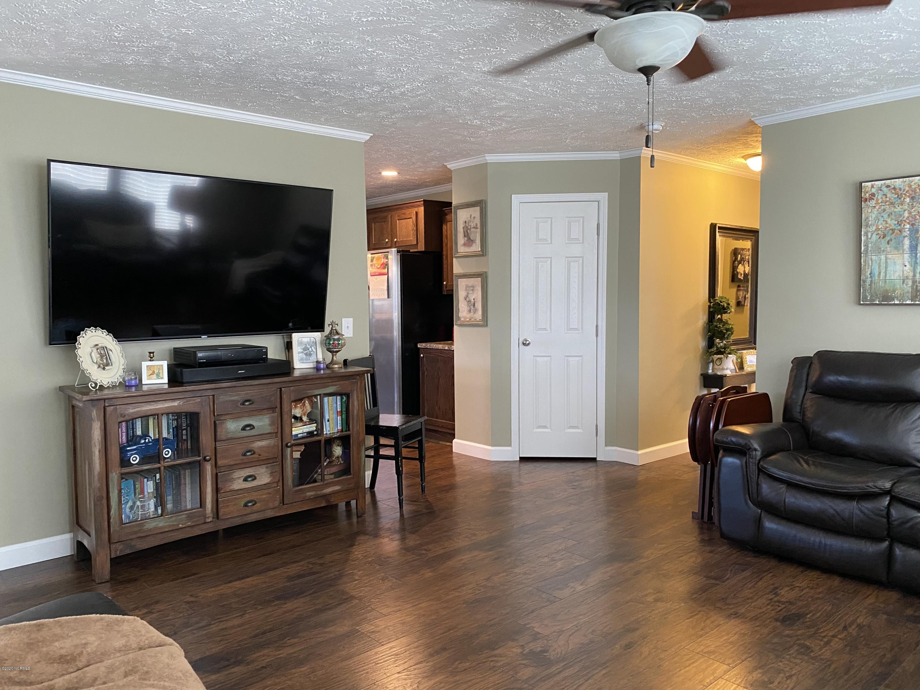 7022 Kingtown Road Northwest Ash, NC 28420 - Photo 6 of 34 Hand scraped Saratoga Hickory laminate flooring in the Great Room/Living Room area