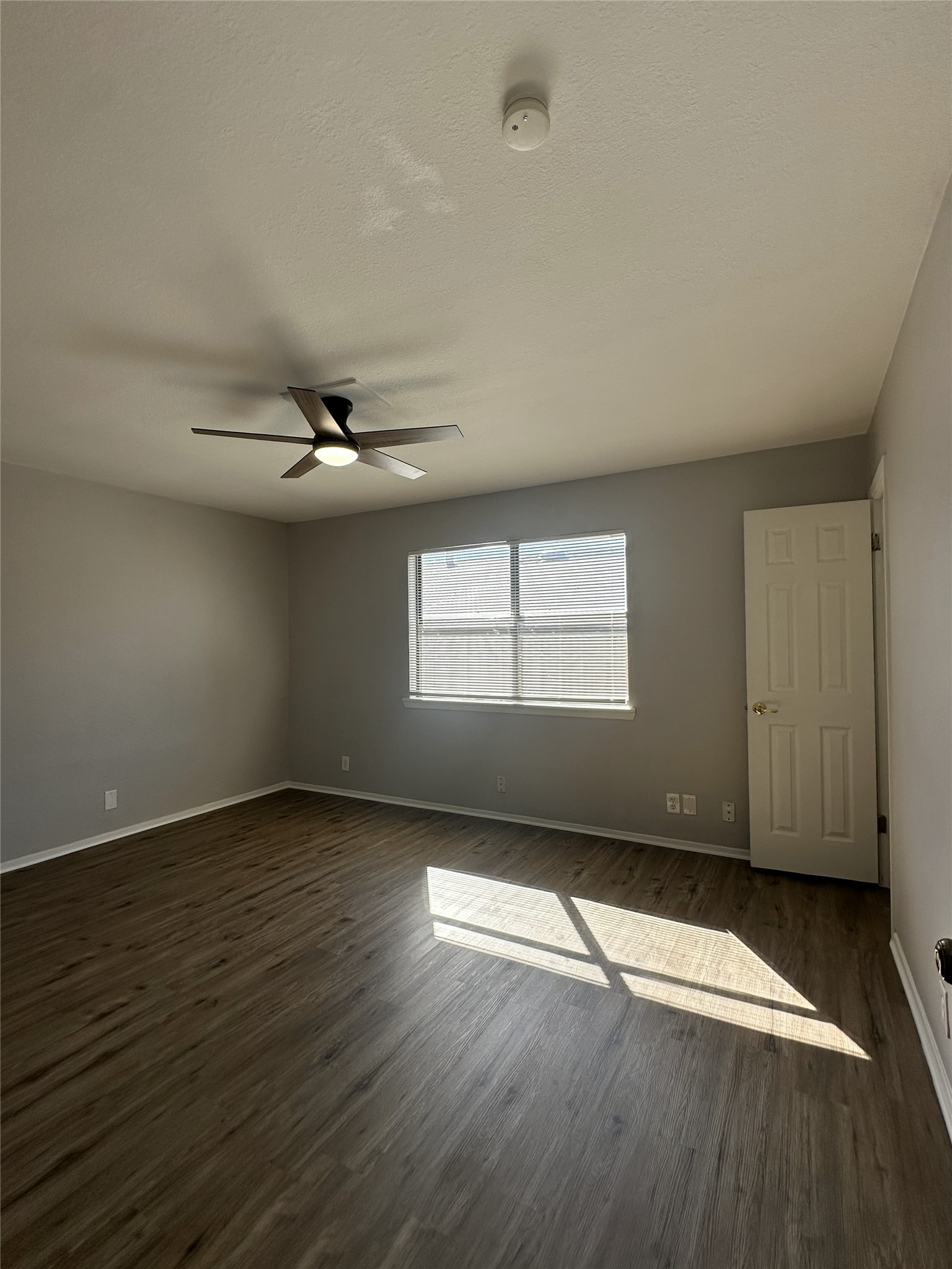 5724 Signal Point Austin, TX 78724 - Photo 13 of 17 Empty room featuring dark wood-type flooring, a textured ceiling, and a ceiling fan