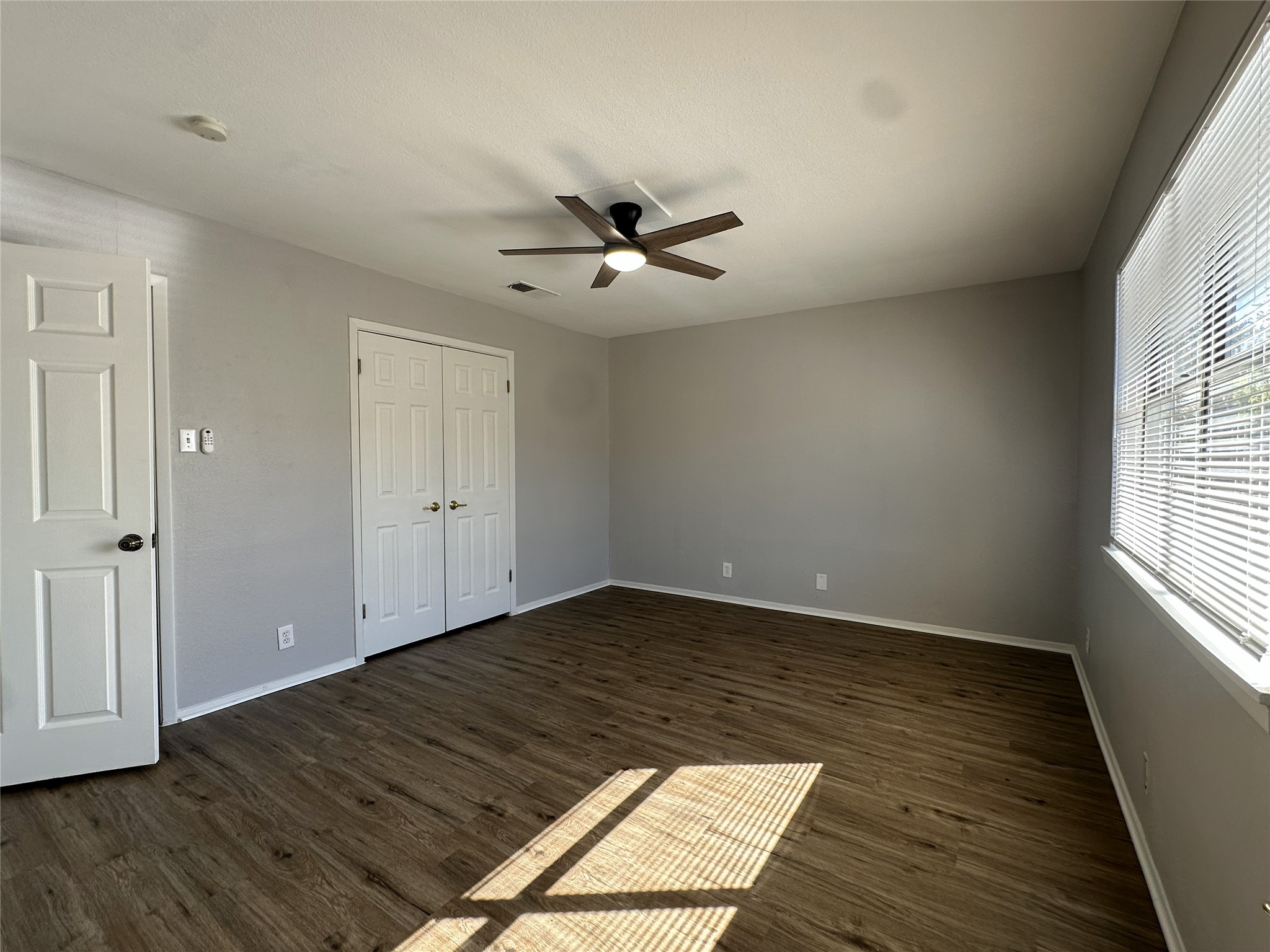 5724 Signal Point Austin, TX 78724 - Photo 14 of 17 Unfurnished bedroom featuring dark wood-style flooring, a closet, and a ceiling fan
