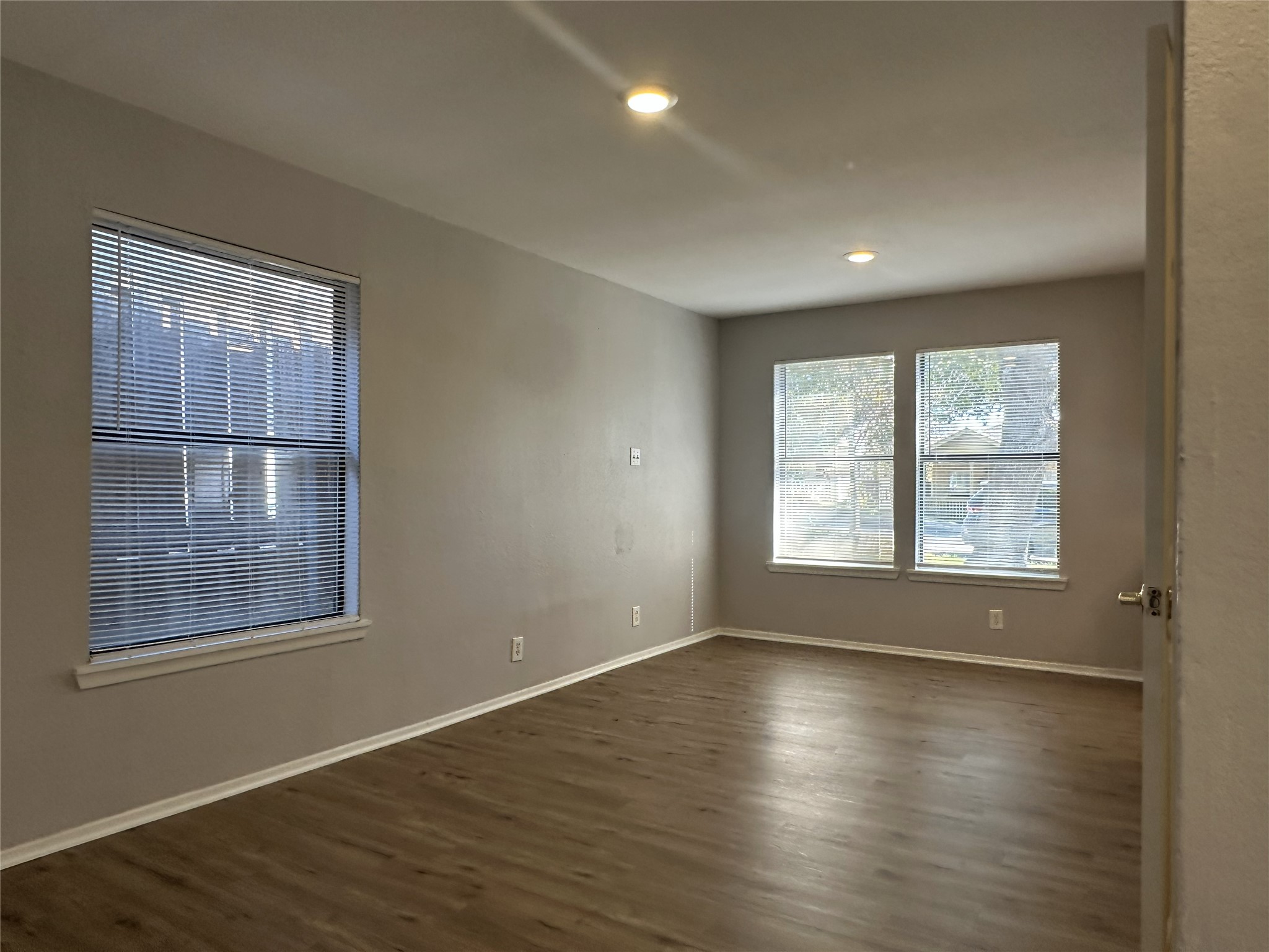 5724 Signal Point Austin, TX 78724 - Photo 5 of 17 Empty room with dark wood-style floors and recessed lighting