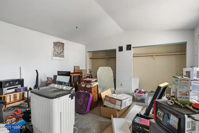 a room with furniture a rug and gym equipment