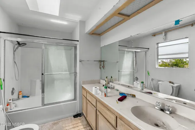 a bathroom with a tub sink toilet and mirror