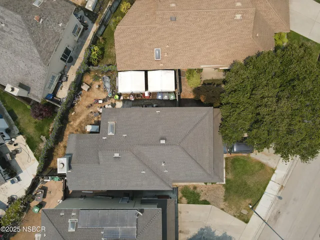 an aerial view of a house with a yard