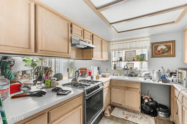 a kitchen with a sink stove and cabinets