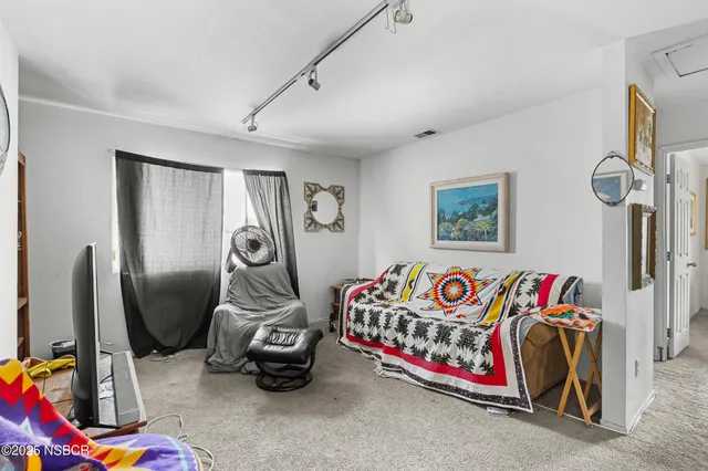 a bedroom with a bed and a couch