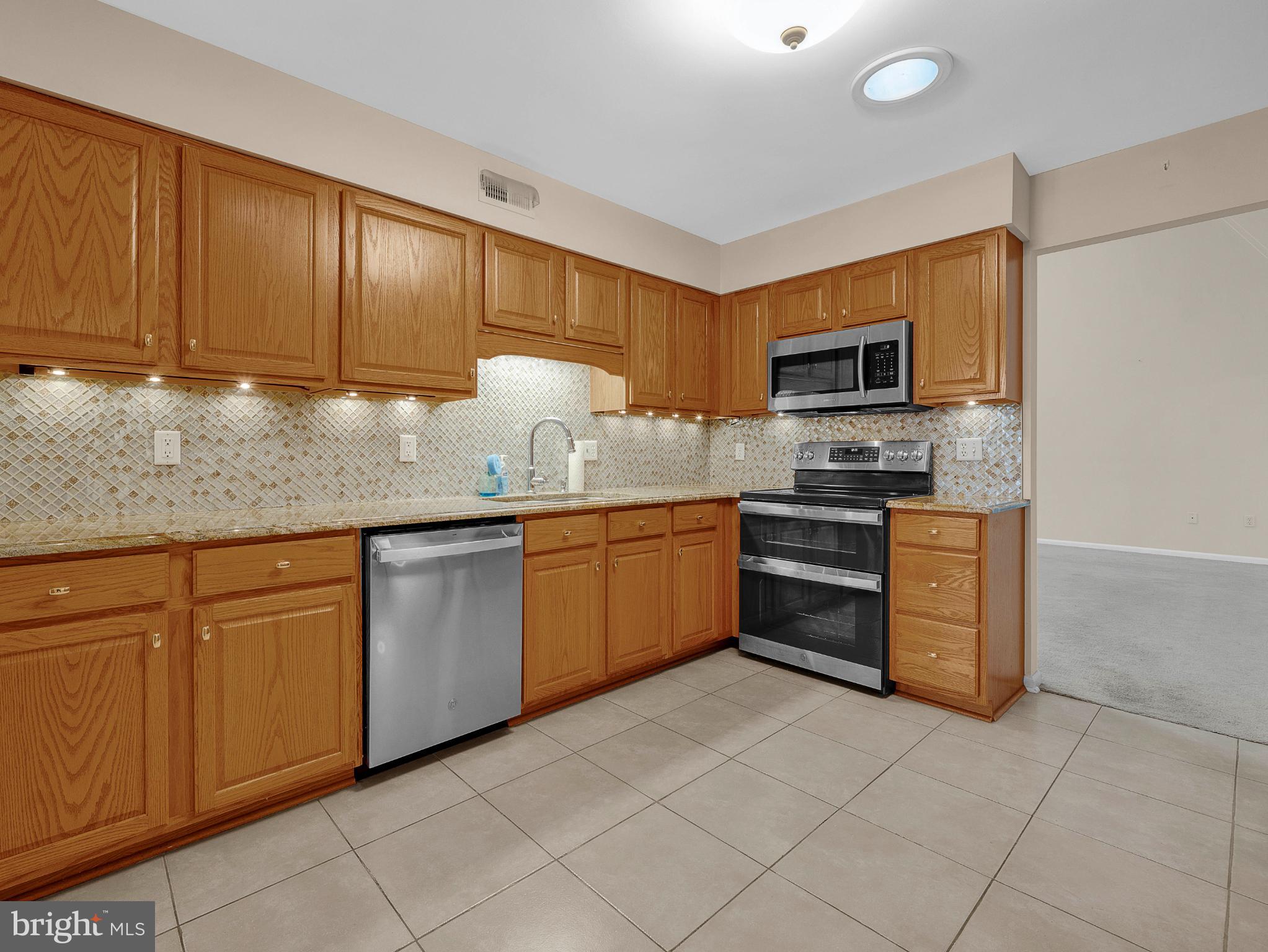 1347 East Thatcher Road Quakertown, PA 18951 - Photo 29 of 47 Modern kitchen with warm wood cabinetry.