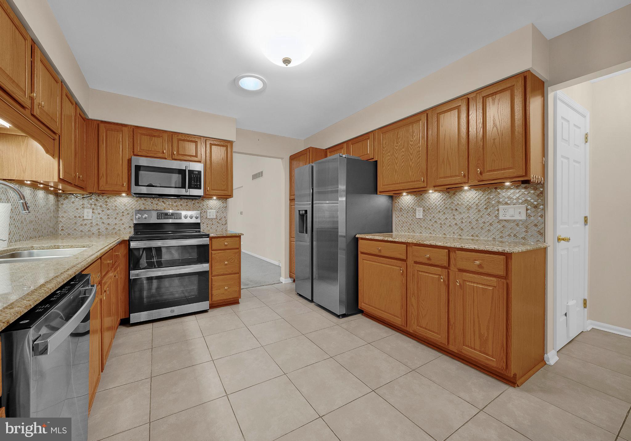 1347 East Thatcher Road Quakertown, PA 18951 - Photo 31 of 47 Modern kitchen with warm wood cabinetry.