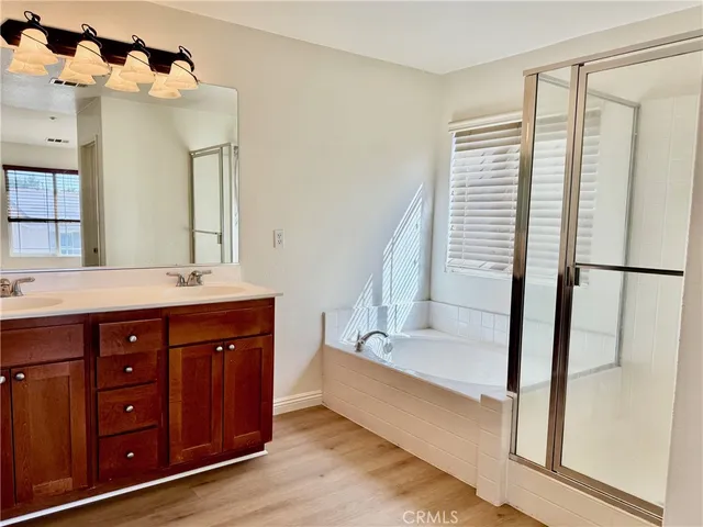 a bathroom with a tub sink and mirror