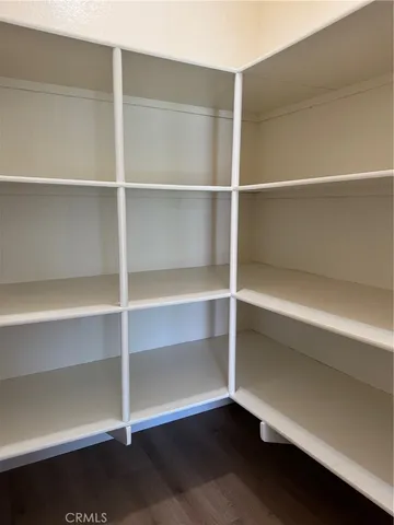 a view of walk in closet with empty racks
