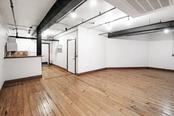 a view of a room with wooden floors