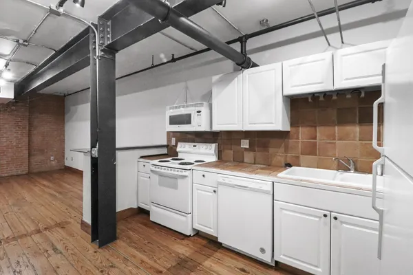 a kitchen with a sink cabinets and appliances