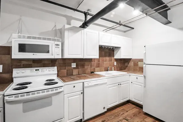 a view of a kitchen with electric appliances