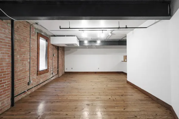 a view of a room with wooden floor