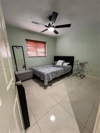 a bedroom with a bed and a ceiling fan