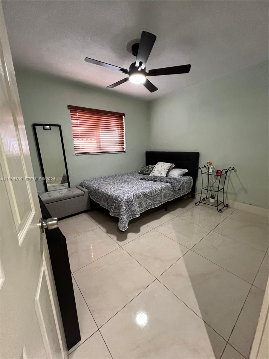 10382 Southwest 25th Street Miami, FL 33165 - Photo 11 of 16 a bedroom with double bed and window
