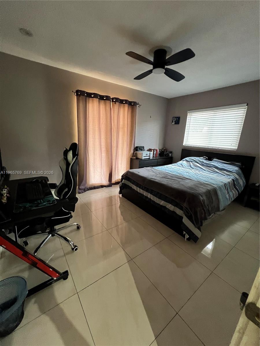 10382 Southwest 25th Street Miami, FL 33165 - Photo 12 of 16 a bedroom with a bed and a ceiling fan