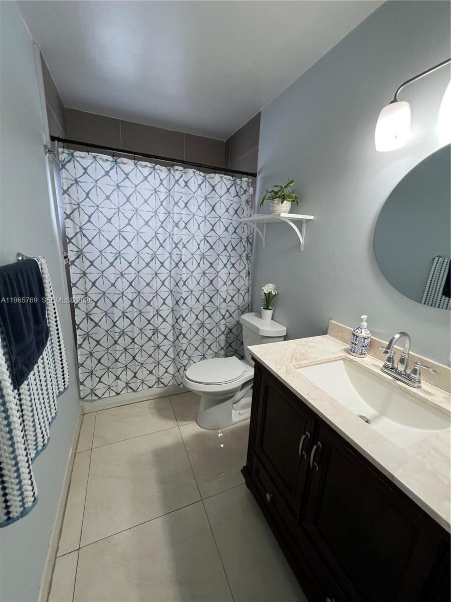 10382 Southwest 25th Street Miami, FL 33165 - Photo 13 of 16 a bathroom with a sink toilet and shower