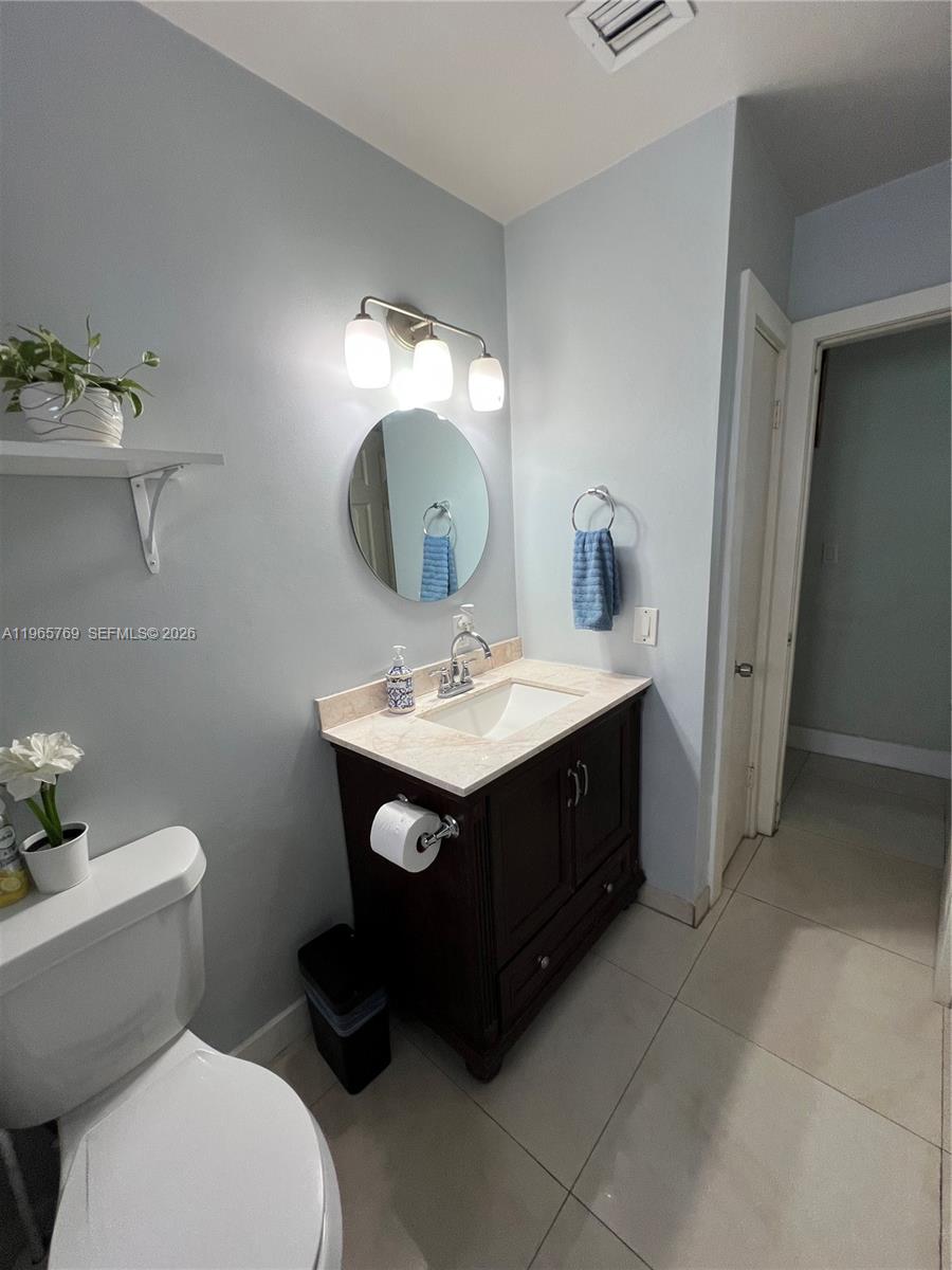 10382 Southwest 25th Street Miami, FL 33165 - Photo 14 of 16 a bathroom with a sink toilet and a mirror