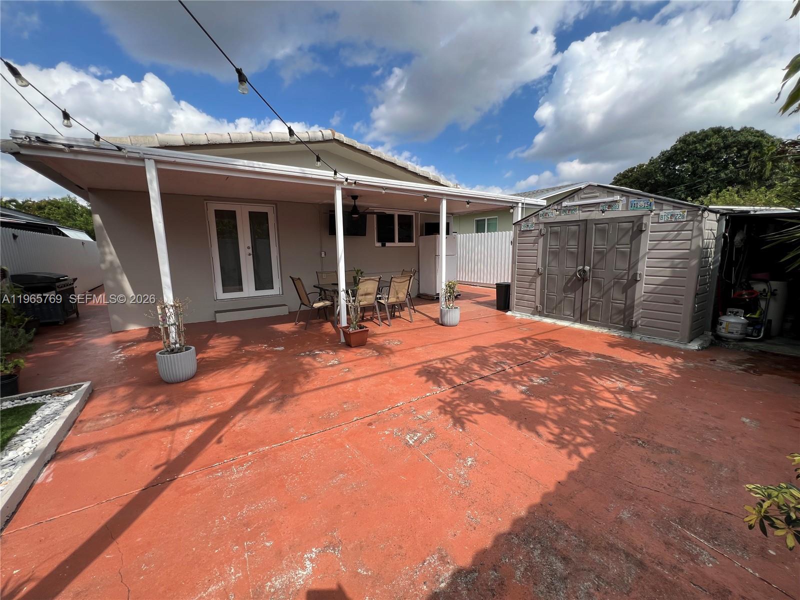 10382 Southwest 25th Street Miami, FL 33165 - Photo 3 of 16 a front view of a house with a yard