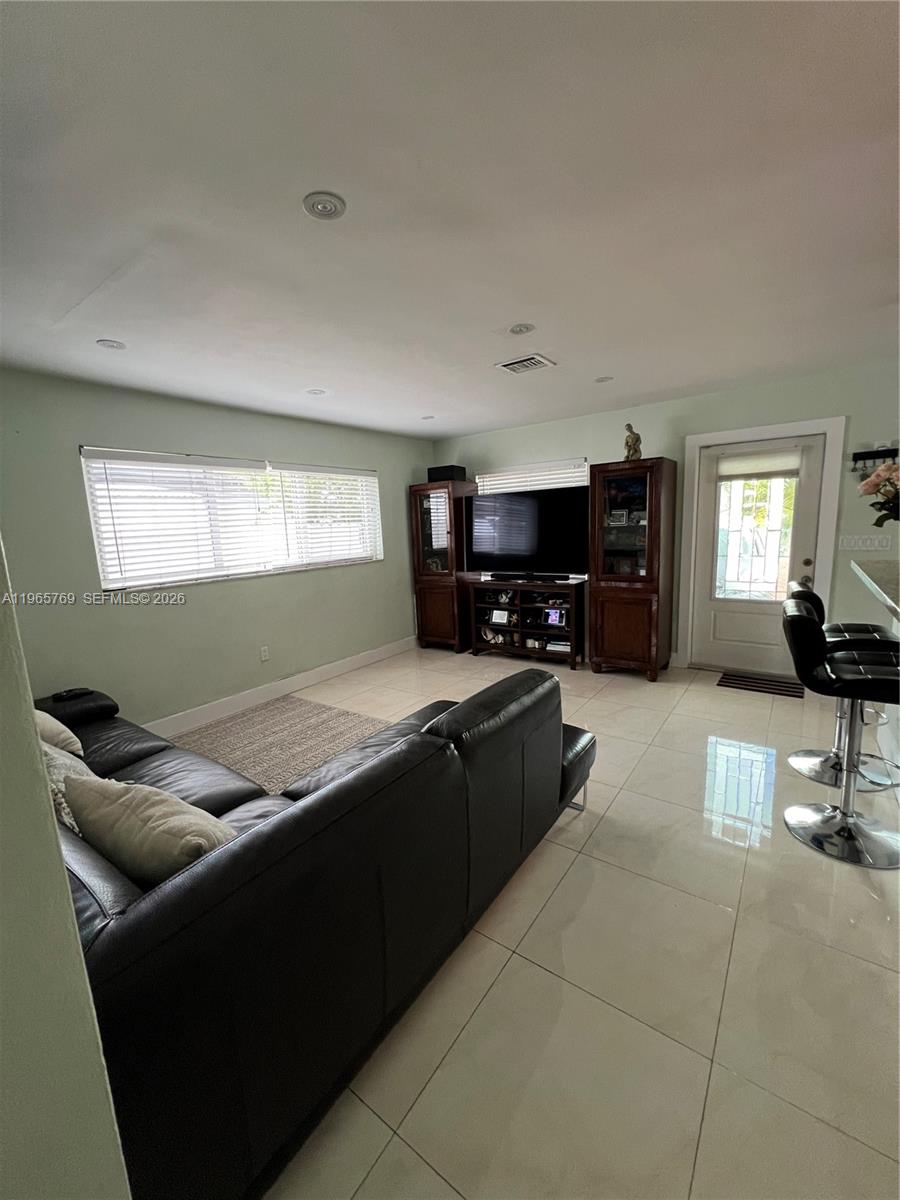10382 Southwest 25th Street Miami, FL 33165 - Photo 4 of 16 a kitchen with granite countertop a stove a sink a refrigerator and a counter top space