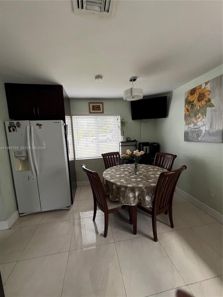 10382 Southwest 25th Street Miami, FL 33165 - Photo 7 of 16 a dining room with furniture and wooden floor