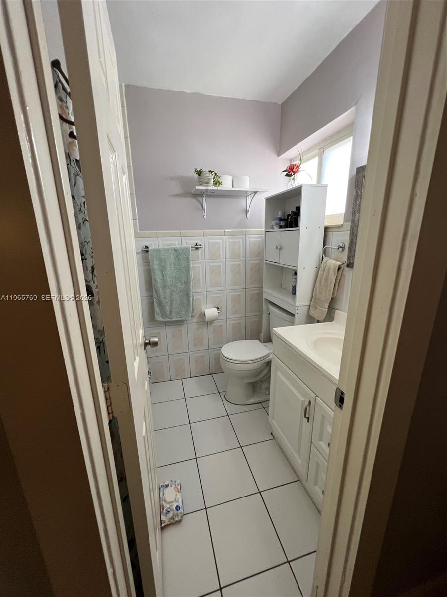10382 Southwest 25th Street Miami, FL 33165 - Photo 10 of 16 a bathroom with a sink a toilet and shower