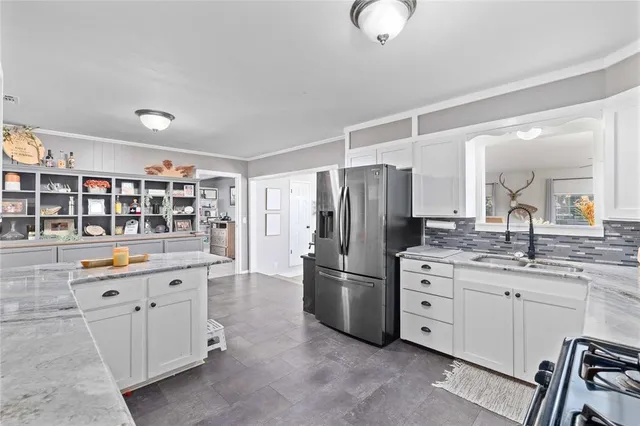 a kitchen with refrigerator and cabinets