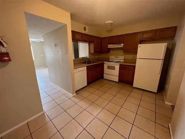 a kitchen with stainless steel appliances granite countertop a refrigerator and a stove
