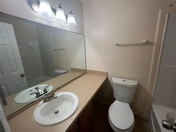 a bathroom with a sink toilet and mirror