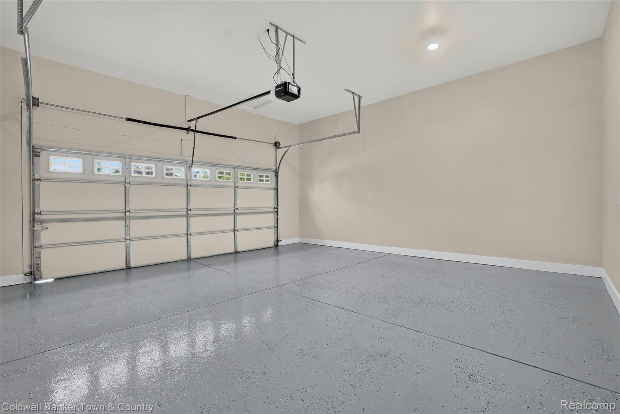 1725 Town Commons Drive Howell, MI 48855 - Photo 22 of 53 Garage with epoxy-coated flooring, neutral wall tones, and recessed lighting