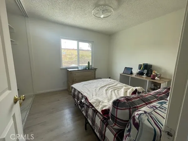 a bed sitting in a bedroom next to a window