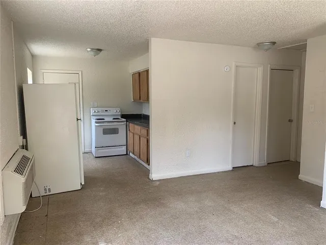 a view of a kitchen with refrigerator stove and a sink