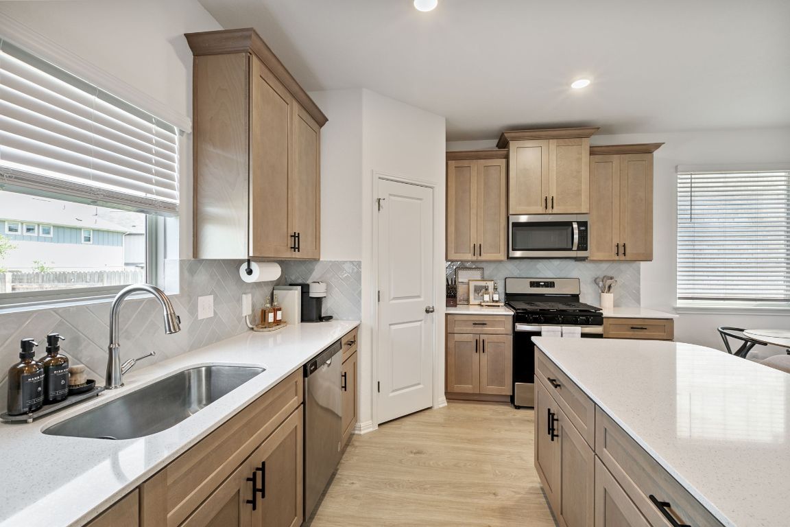 615 Backstays Loop Kyle, TX 78640 - Photo 11 of 36 a kitchen with stainless steel appliances granite countertop a sink dishwasher stove and refrigerator