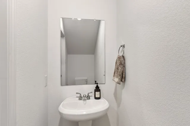 a bathroom with a sink and mirror