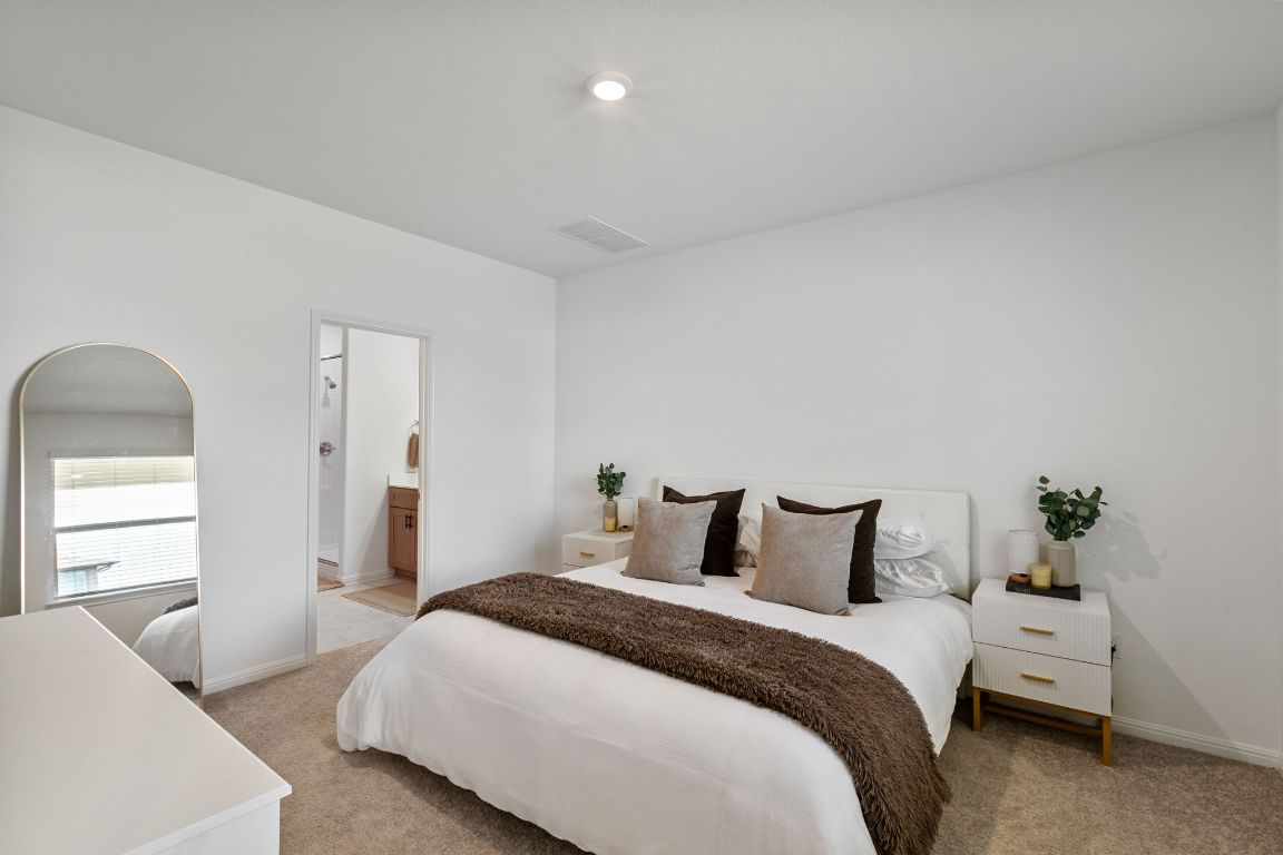 615 Backstays Loop Kyle, TX 78640 - Photo 15 of 36 a bedroom with a bed and a couch