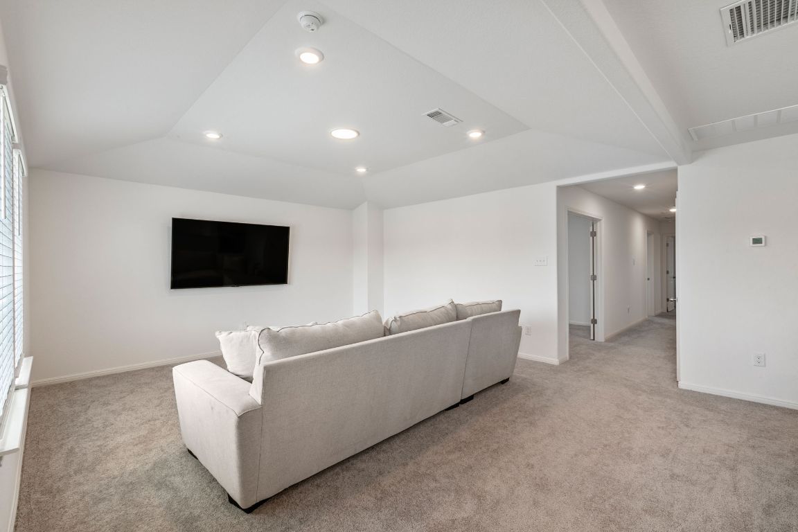 615 Backstays Loop Kyle, TX 78640 - Photo 21 of 36 a living room with furniture and a flat screen tv