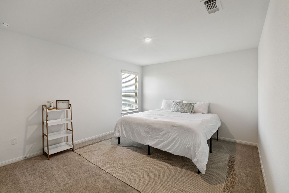 615 Backstays Loop Kyle, TX 78640 - Photo 30 of 36 a bedroom with a bed and a window