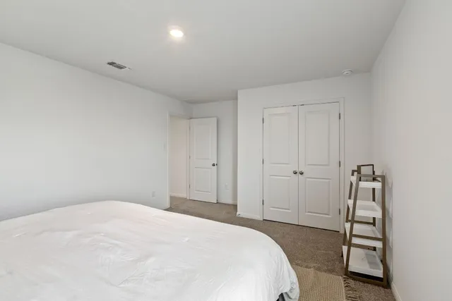 a bedroom with a bed and a cabinets