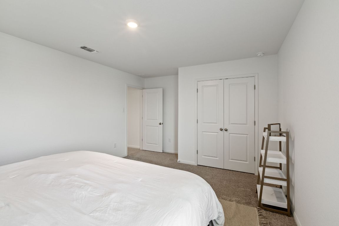 615 Backstays Loop Kyle, TX 78640 - Photo 31 of 36 a bedroom with a bed and a cabinets