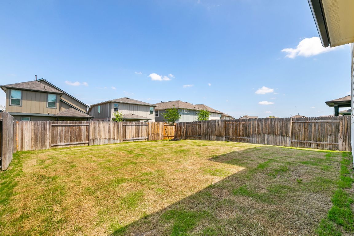 615 Backstays Loop Kyle, TX 78640 - Photo 34 of 36 a view of an house with backyard and a tree