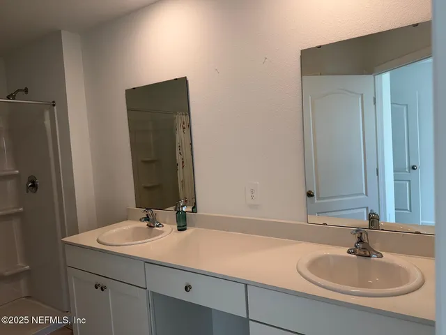 a bathroom with a sink and mirror