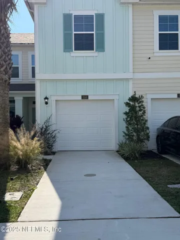 a kitchen with white cabinets and black appliances