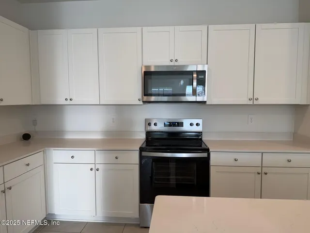 a white refrigerator freezer sitting in a kitchen