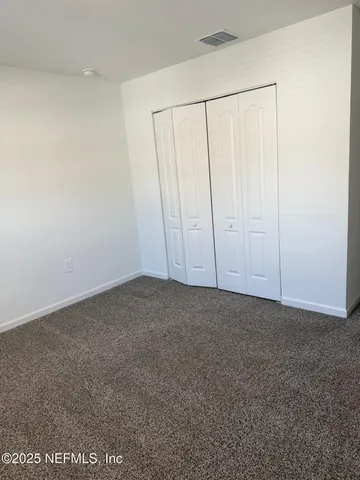 a white toilet sitting next to a shower